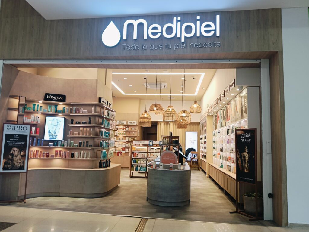 Medopiel storefront interior with curved beige counter and shelves of skincare products inside a well-lit beauty shop.