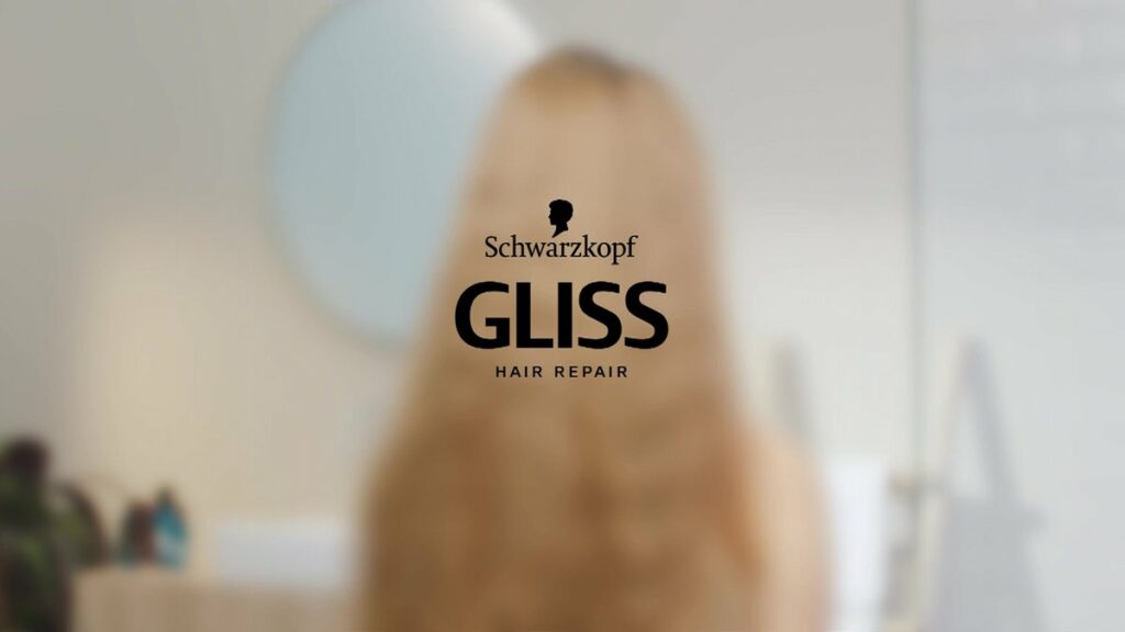 Schwarzkopf GLISS hair repair logo centered on a blurred background with a person silhouette behind it