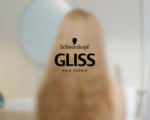 Schwarzkopf GLISS hair repair logo centered on a blurred background with a person silhouette behind it
