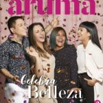 Group of four women smiling and posing with confetti against a pink backdrop, celebrating beauty with the words 'Celebra Belleza' and brand 'aruma.pe' visible.
