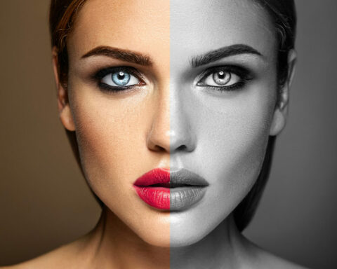 Split-image portrait of a woman: left side in color with blue eye and pink lips, right side in grayscale.